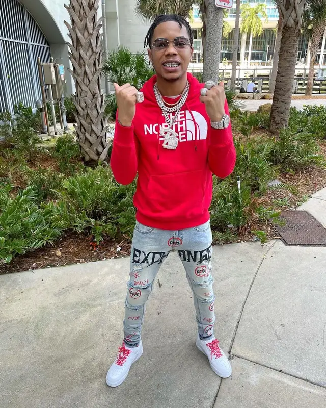 Lil Migo outfit in The North Face, Louis Vuitton, and James Oro, 2022