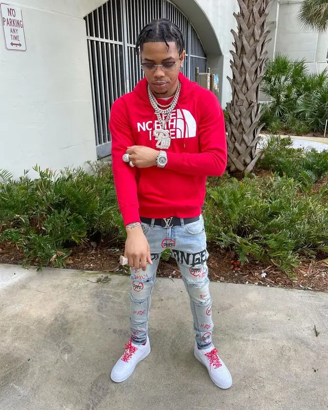 Lil Migo outfit in The North Face, Louis Vuitton, and James Oro, 2022