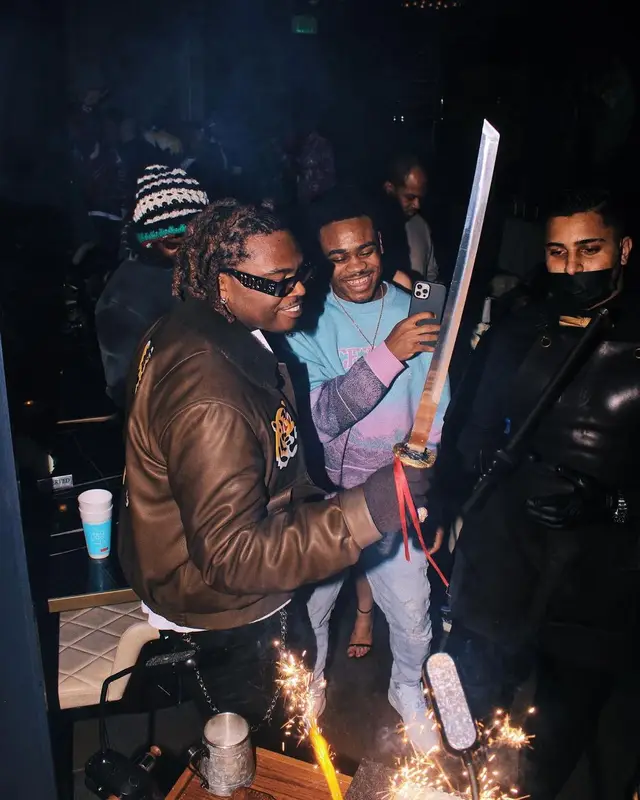 Gunna outfit in Louis Vuitton, Purple Brand, and Palm Angels, 2022