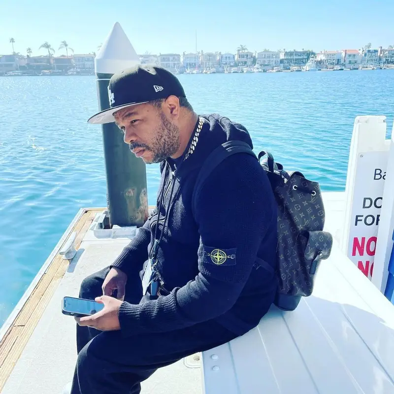 Xzibit outfit in Stone Island, Louis Vuitton, and New Era, 2022