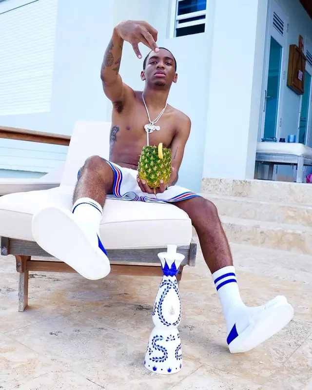 Bizzy Banks outfit in Louis Vuitton, NBA, and Amiri, 2021