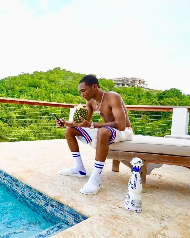 Bizzy Banks outfit in Louis Vuitton, NBA, and Amiri, 2021