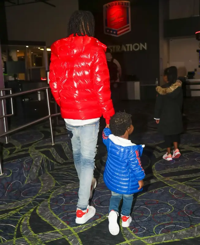 Polo G outfit in Purple Brand, Alexander McQueen, and Moncler, 2022