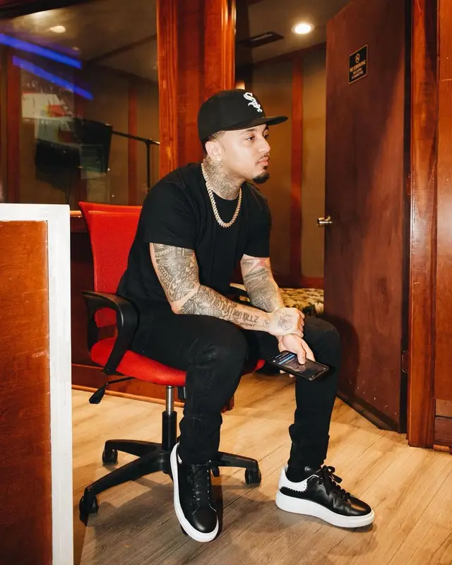 Kirko Bangz outfit in Polo Ralph Lauren, Alexander McQueen, and New Era, 2022