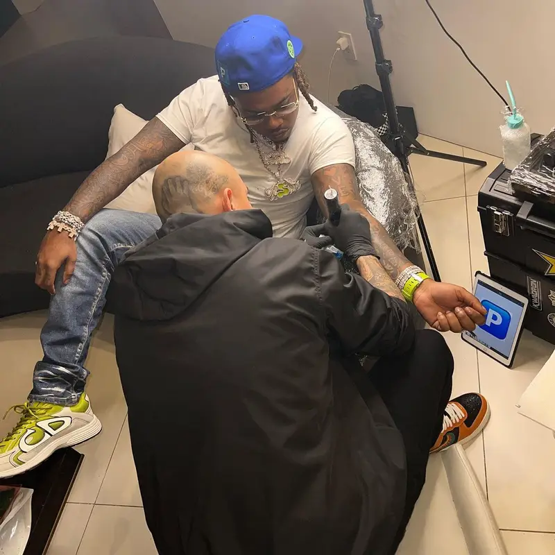 Gunna outfit in Bottega Veneta, Purple Brand, and Dior, 2022