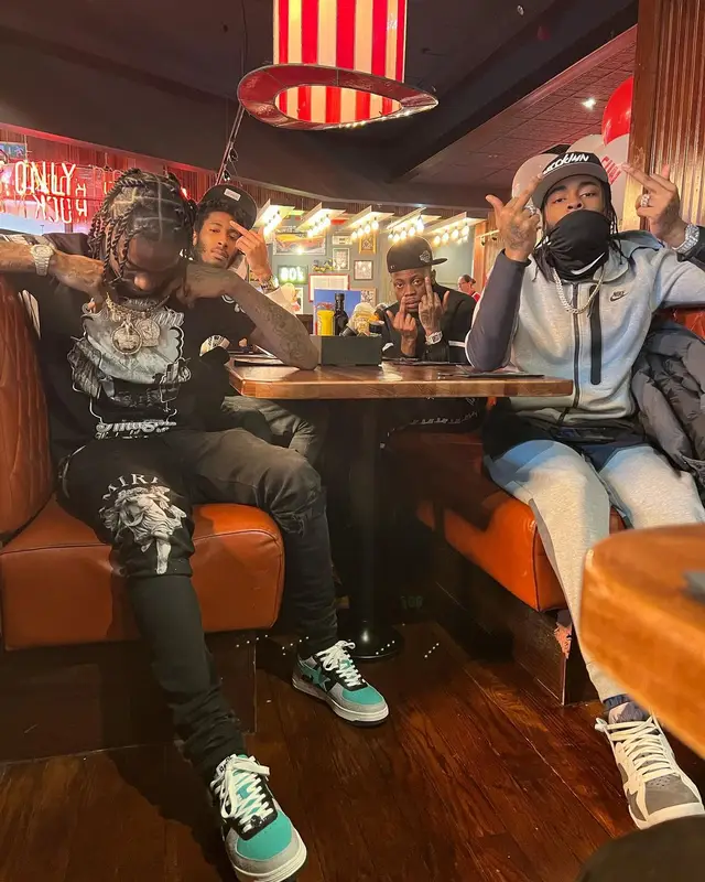 Russ Millions outfit in Moose Knuckles, Louis Vuitton, and Amiri, 2022