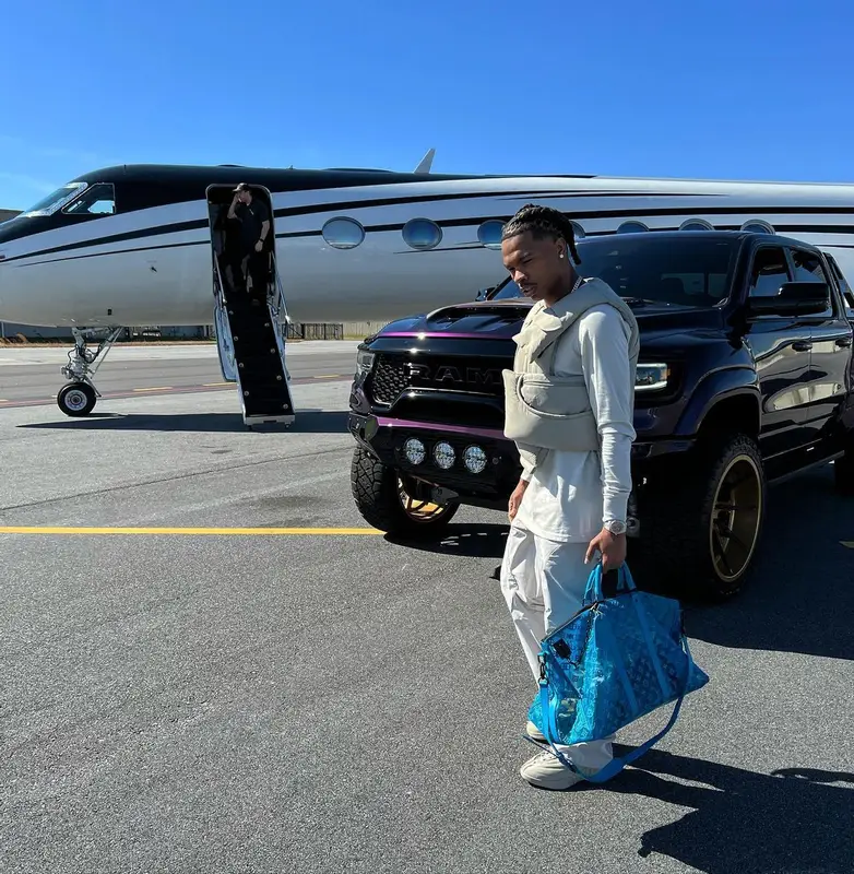 Lil Baby outfit in Post Archive Faction, Jordan, and Louis Vuitton, 2022