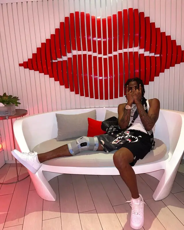 Russ Millions outfit in Bape, Louis Vuitton, and Alexander McQueen, 2022