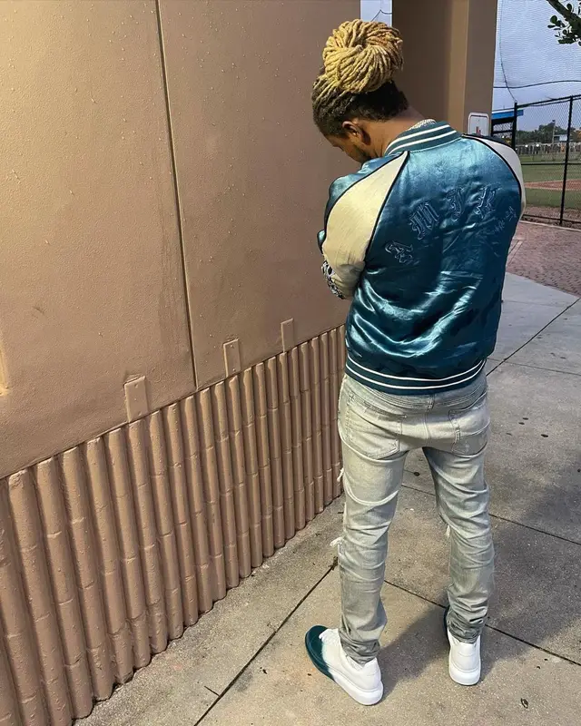100k Track outfit in Amiri, Louis Vuitton, and Versace, 2022