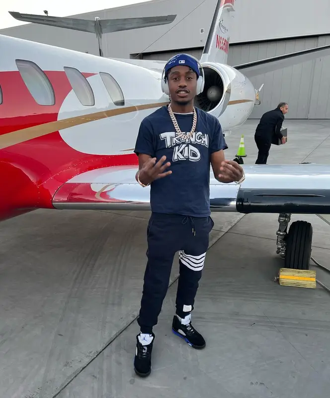 Lil Tjay outfit in Dior, Thom Browne, and Jordan, 2022
