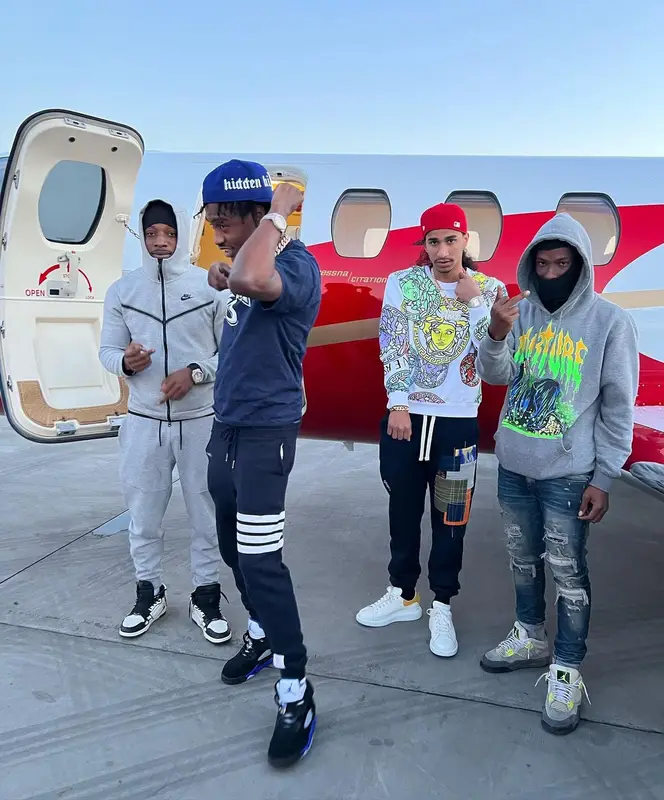 Lil Tjay outfit in Dior, Thom Browne, and Jordan, 2022