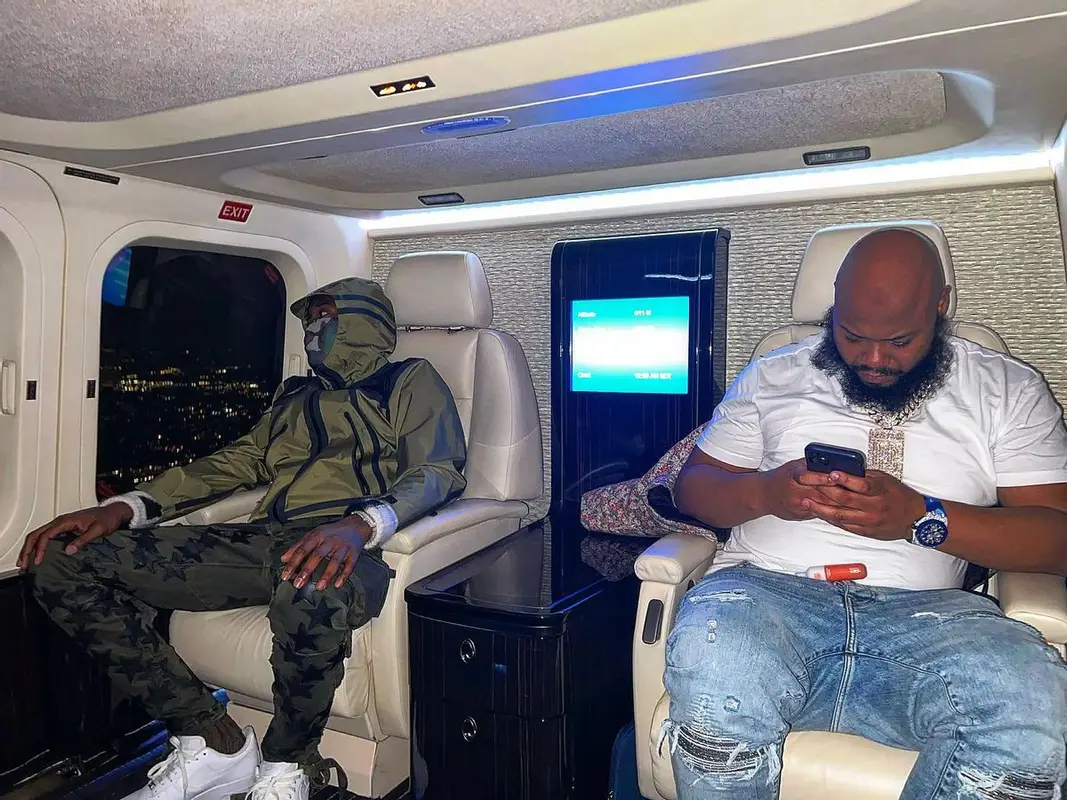 Meek Mill outfit in Supreme, Amiri, and The North Face, 2022