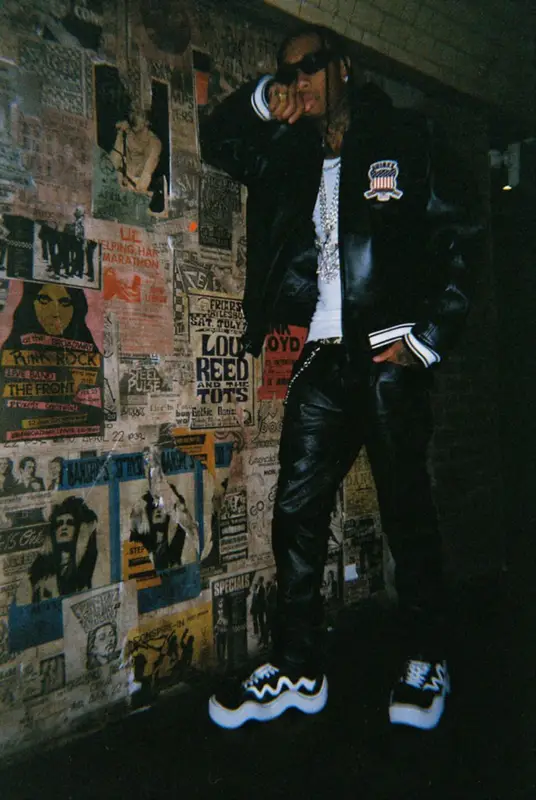 Tyga outfit in Avirex, Nyrva, and Versace, 2022