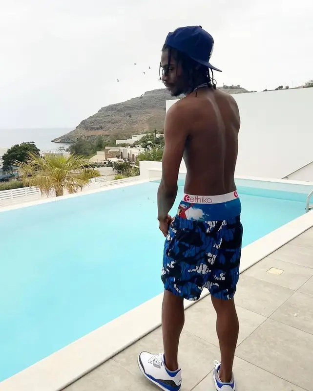 Russ Millions outfit in Jordan, New Era, and Moving Kilos, 2022