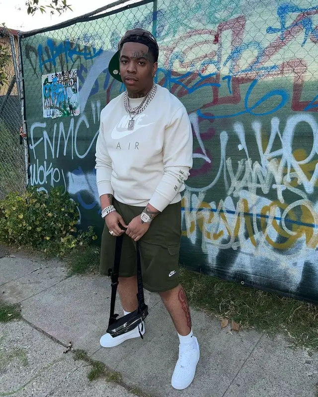 Lil Gotit outfit in Burberry, Fear of God, and New Era, 2022