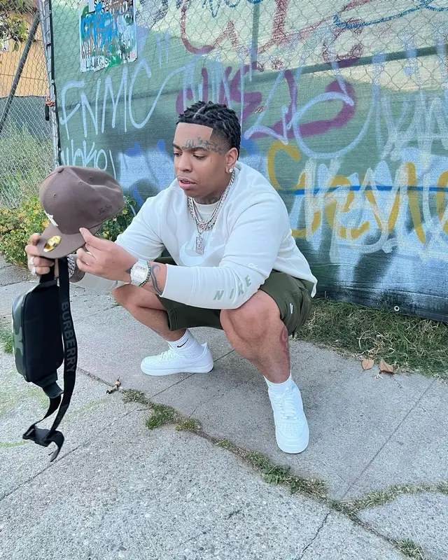Lil Gotit outfit in Burberry, Fear of God, and New Era, 2022