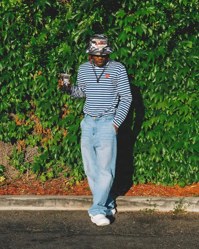 CKay outfit in Comme Des Garcons, RAW Rolling Papers, and Crocs, 2022
