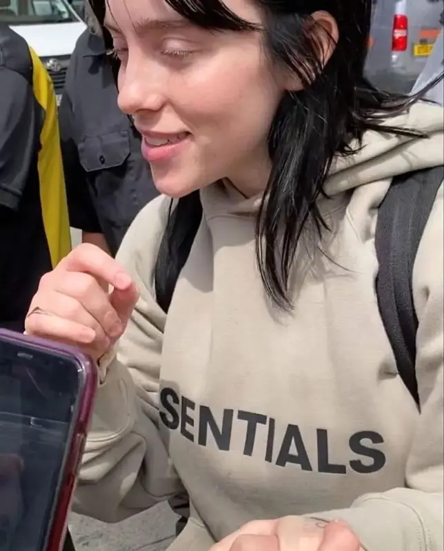 Billie Eilish outfit in Fear of God and Moon Boot, 2022
