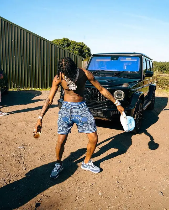 Russ Millions outfit in Amiri, Louis Vuitton, and New Era, 2022