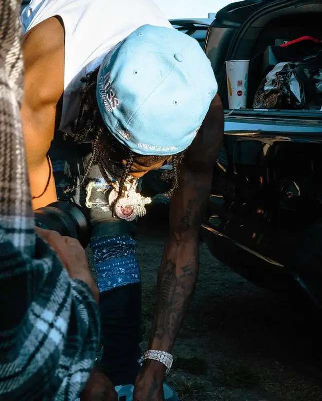 Russ Millions outfit in Amiri, Louis Vuitton, and New Era, 2022