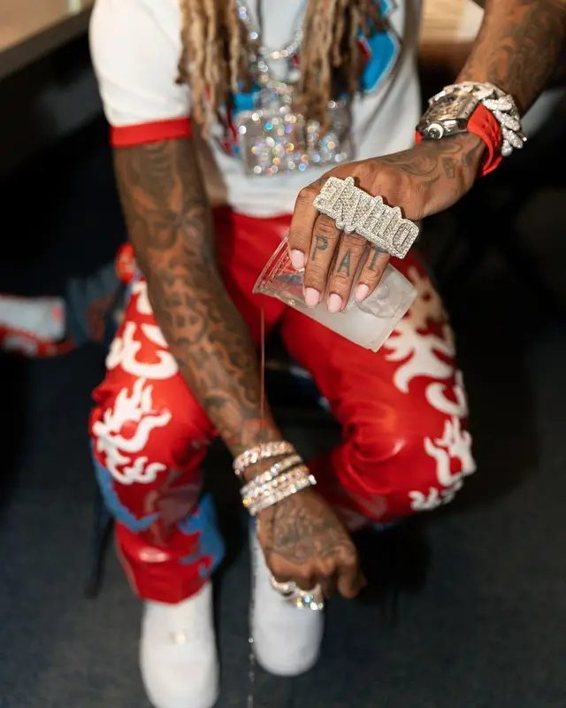 Lil Durk outfit in Louis Vuitton, RoyGBiv, and Nike, 2022