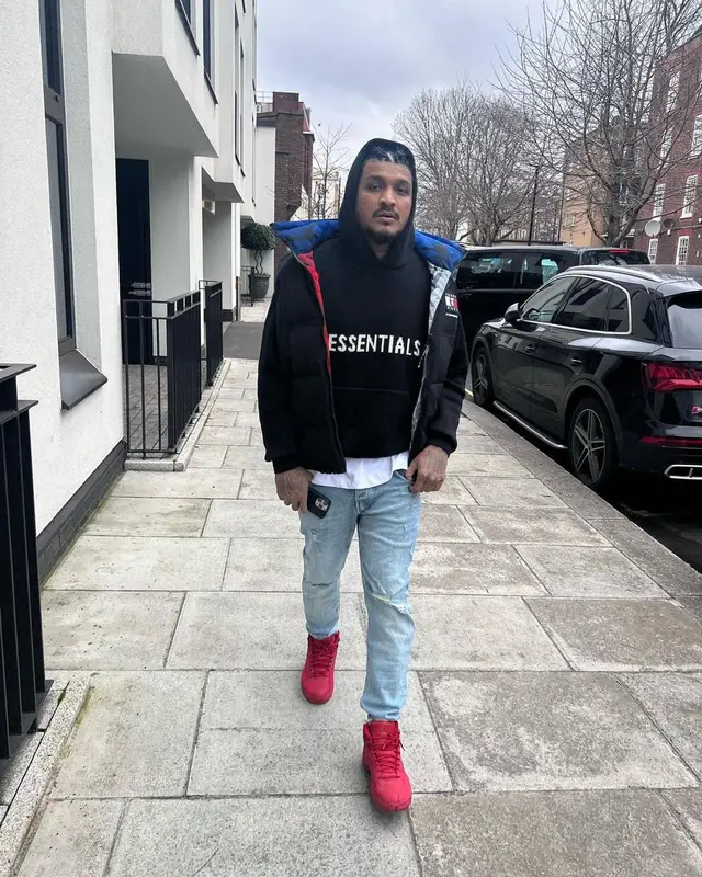Divine outfit in Tommy Hilfiger, Fear of God, and Aape, 2022