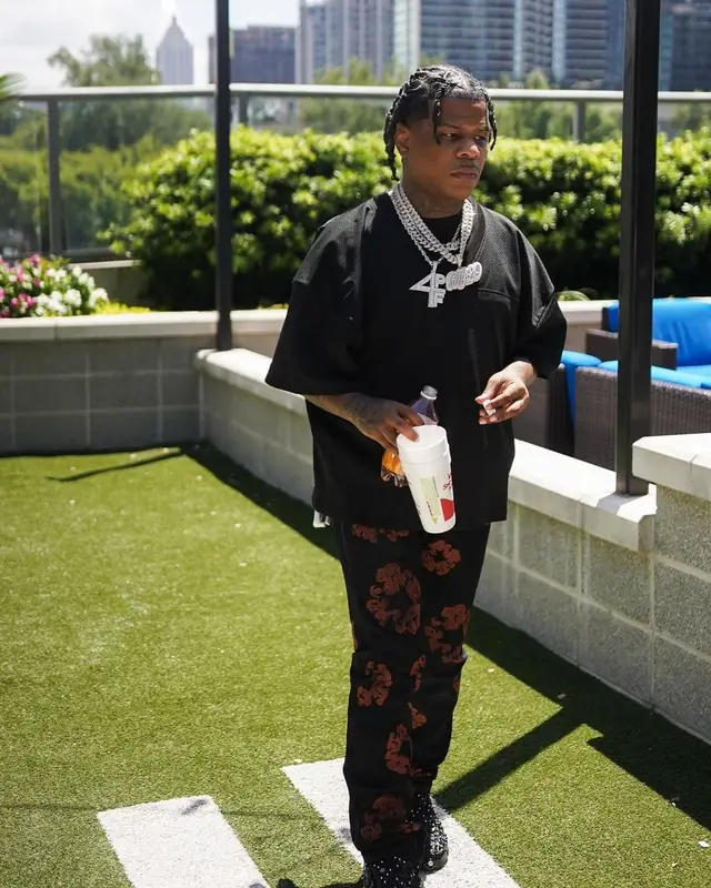 Rylo Rodriguez outfit in Fear of God, Denim Tears, and Loewe, 2022