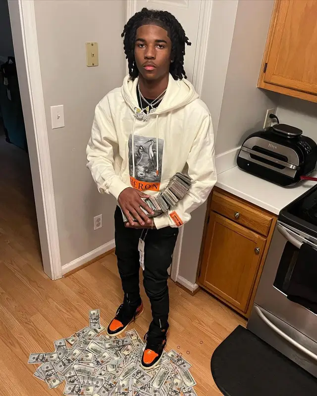 Lil Darius outfit in Heron Preston, Purple Brand, and Nike, 2022