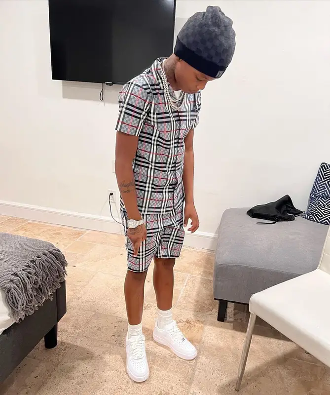 Lil 50 outfit in Burberry, Nike, and Louis Vuitton, 2022