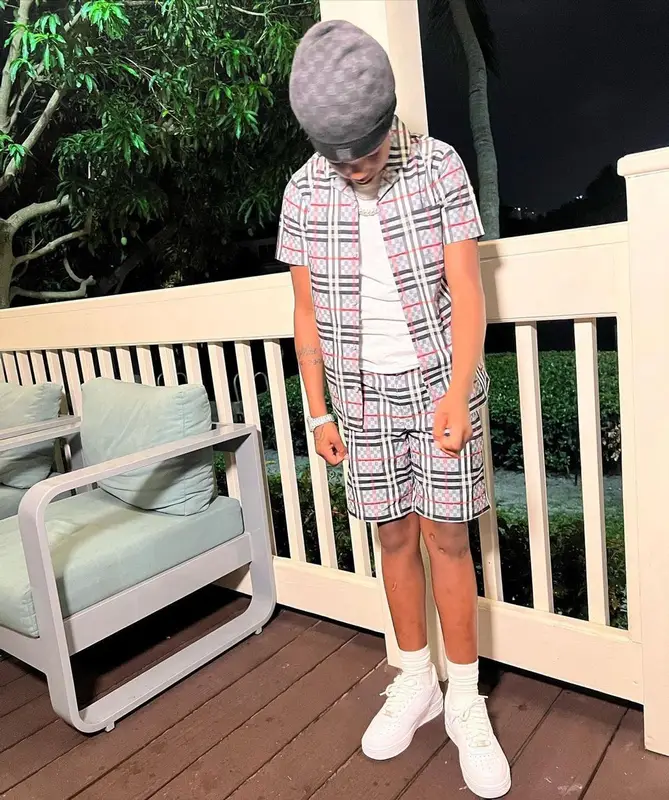 Lil 50 outfit in Burberry, Nike, and Louis Vuitton, 2022