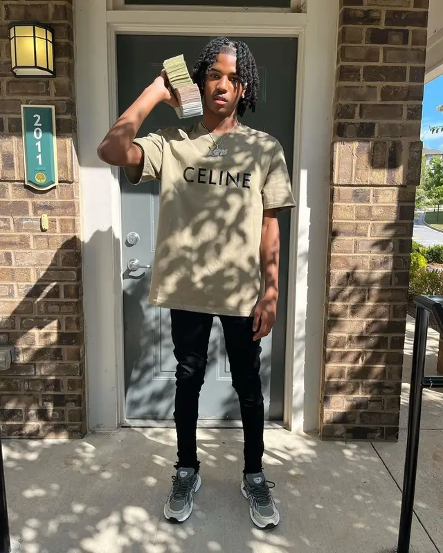 Lil Darius outfit in Celine, Purple Brand, and Dior, 2022