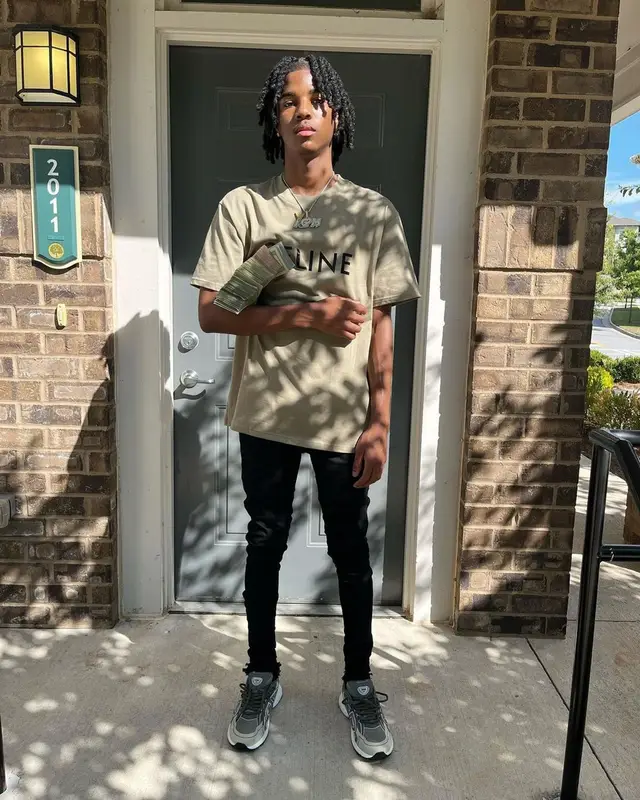 Lil Darius outfit in Celine, Purple Brand, and Dior, 2022