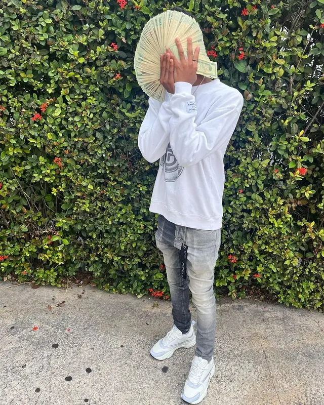 Lil Darius outfit in Gallery Dept., Purple Brand, and Dior, 2022