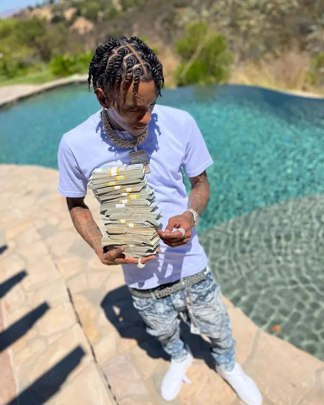 Soulja Boy outfit in Purple Brand, Nike, and Burberry, 2022