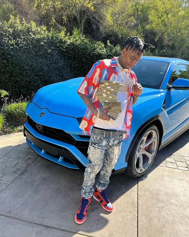 Soulja Boy outfit in Purple Brand, Nike, and Burberry, 2022