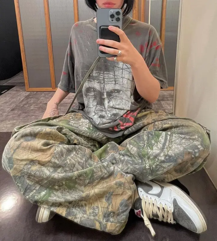 Billie Eilish outfit in Nike, StoreRoomVintage, and Travis Scott Merch, 2022