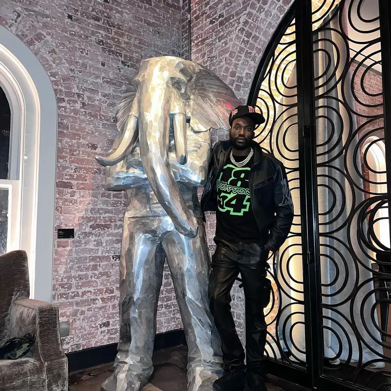 Meek Mill outfit in Louis Vuitton and Amiri, 2022