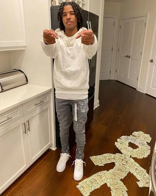 Lil Darius outfit in Spider Worldwide, Purple Brand, and Nike, 2022
