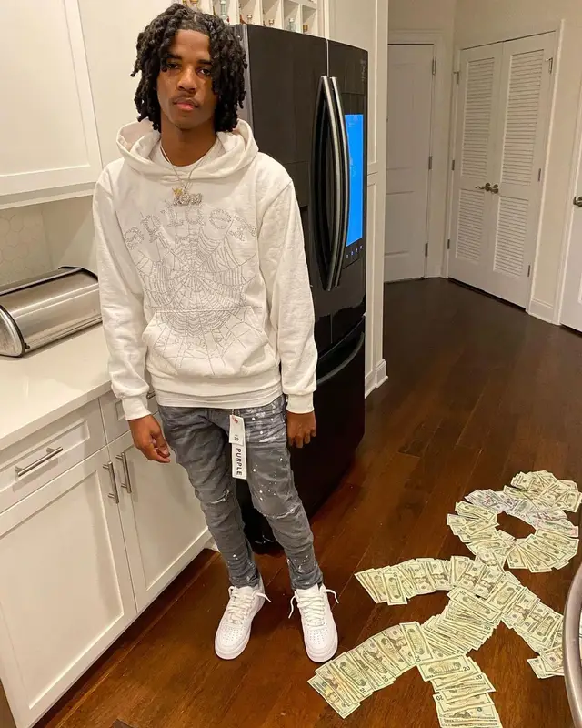 Lil Darius outfit in Spider Worldwide, Purple Brand, and Nike, 2022