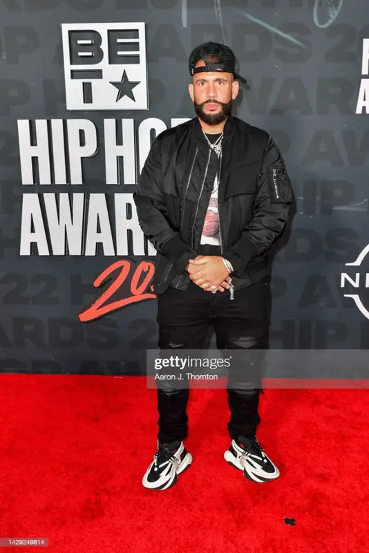 DJ Drama outfit in Mitchell & Ness, Balmain, and Amiri, 2022