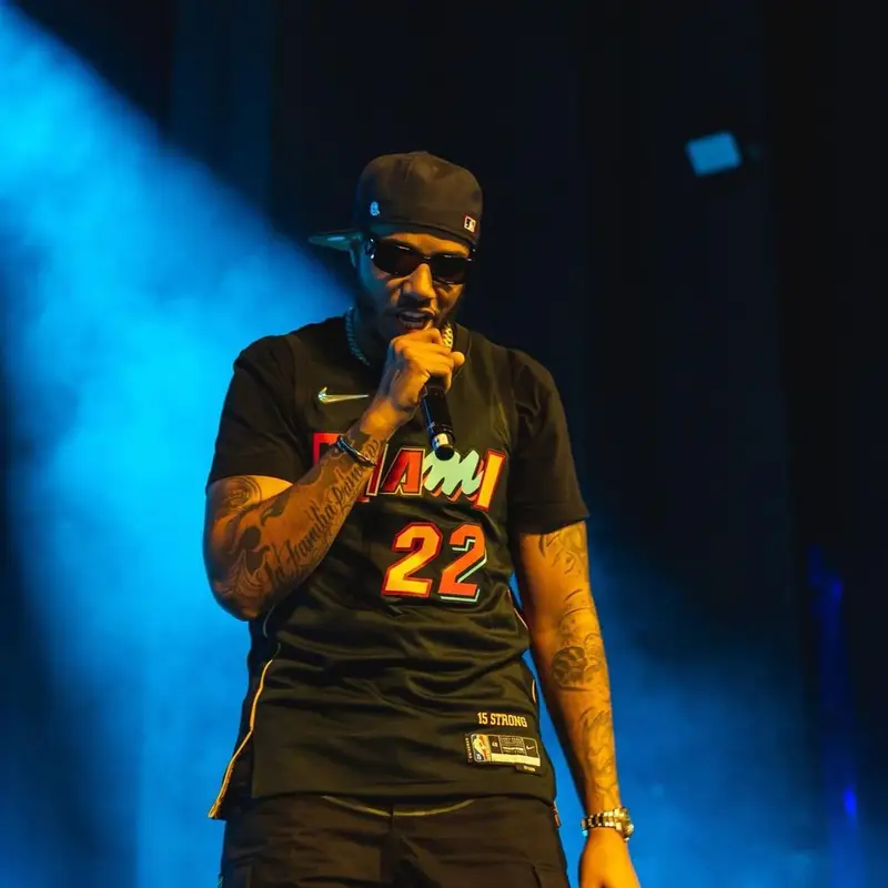 AJ Tracey outfit in Nike, Skepta Merch, and Prada, 2022