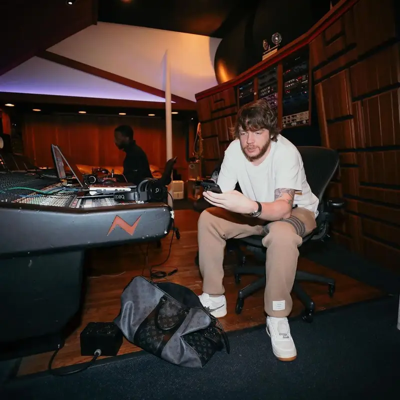Murda Beatz outfit in Thom Browne, Nike, and Travis Scott Merch, 2022