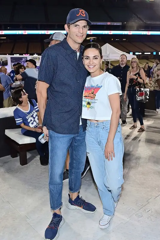 Mila Kunis outfit in Jordache, Etica, and Converse, 2022