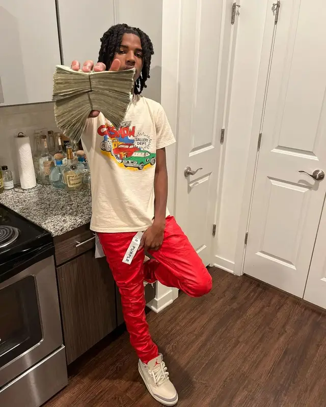 Lil Darius outfit in Gallery Dept., Purple Brand, and Jordan, 2022