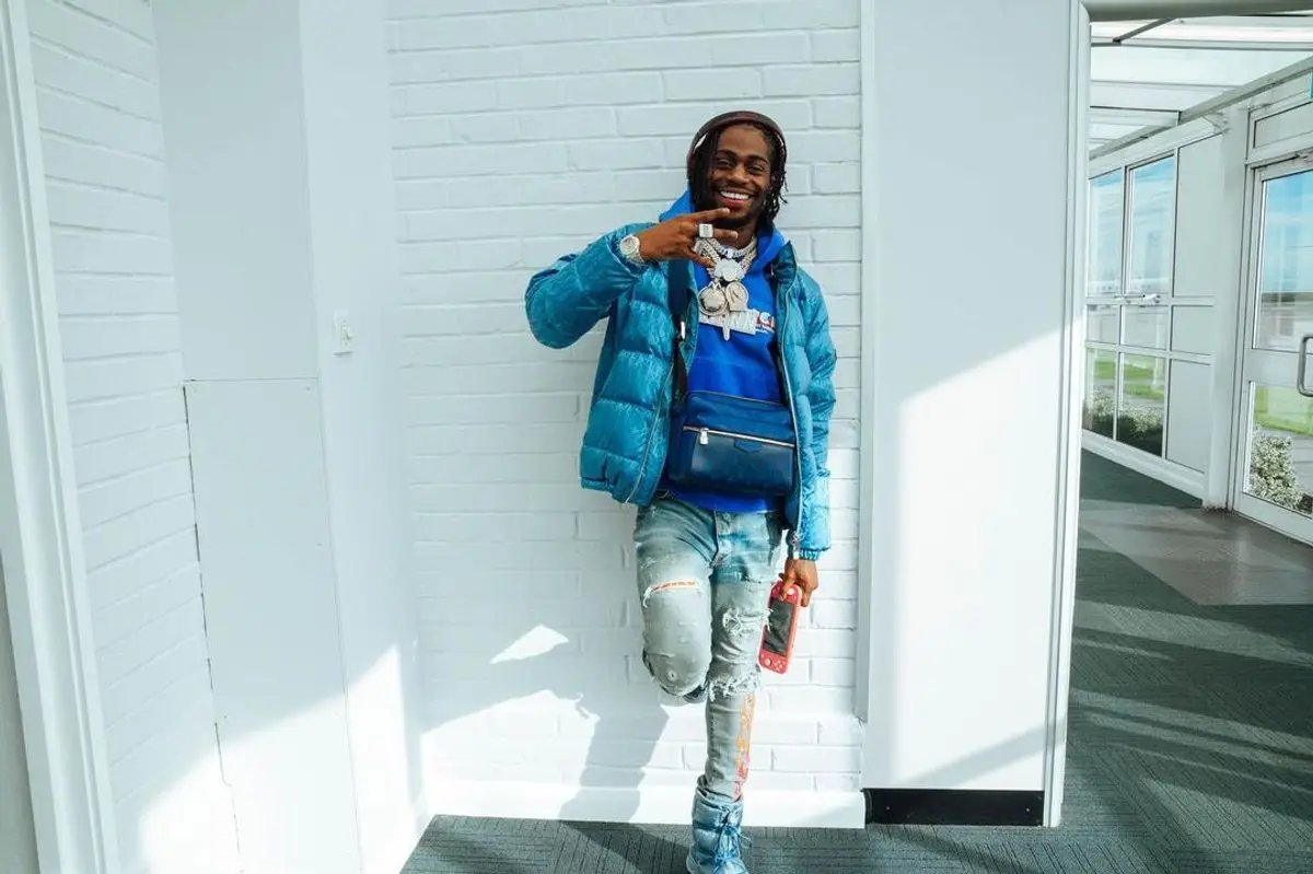 Russ Millions outfit in Dior, Amiri, and Louis Vuitton, 2022