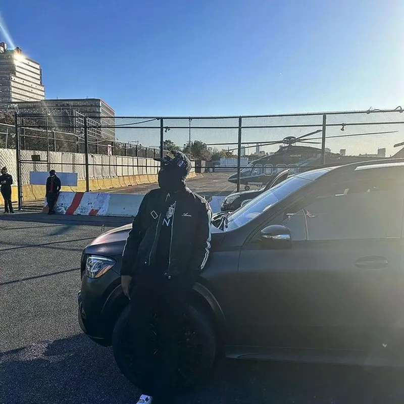 Meek Mill outfit in Amiri, Louis Vuitton, and Nike, 2022