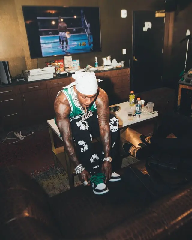 DaBaby outfit in Mitchell & Ness, Levi’s, and Denim Tears, 2022