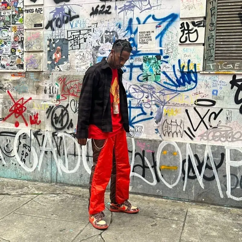 Travis Scott outfit in Balenciaga, Issey Miyake, and Nike, 2022