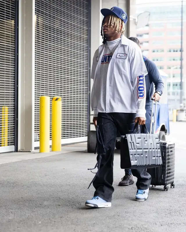 Xavier McKinney outfit in Peels, Louis Vuitton, and Jordan, 2022