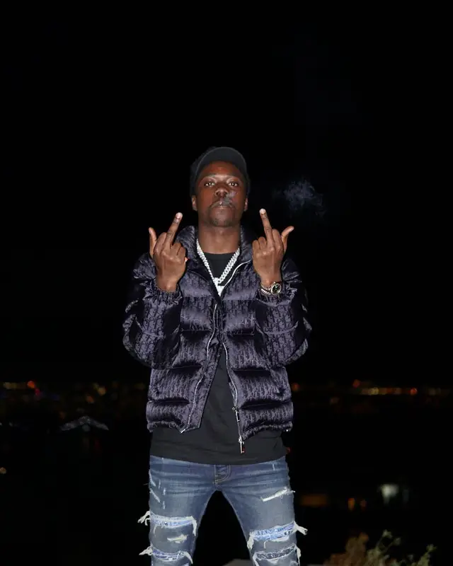 Burna Bandz outfit in Dior, Polo Ralph Lauren, and Amiri, 2022
